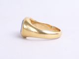 an image of a gold ring with a blue stone
