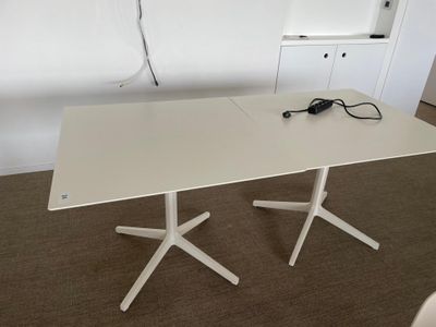 a white table with two white legs and a white table top