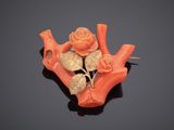 an image of a piece of carved coral with a rose on it