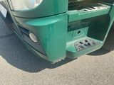 a close up of a green truck with a piano in the back