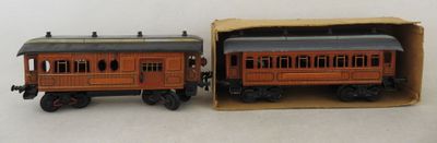 two toy trains sitting in a box on a table