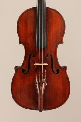 an old violin with a bow hanging from it ' s back