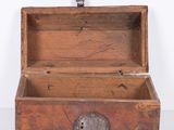 a small wooden box with a key in it