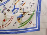 a blue and white scarf with a picture of a polar bear on a sleigh