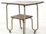 a small table with a stool on wheels on a white floor
