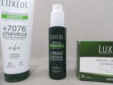 a bottle of lotion and a tube of lotion next to a tube of lotion