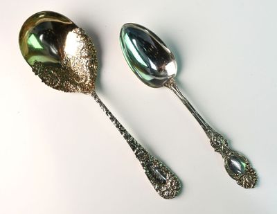 two spoons and a spoon on a white surface