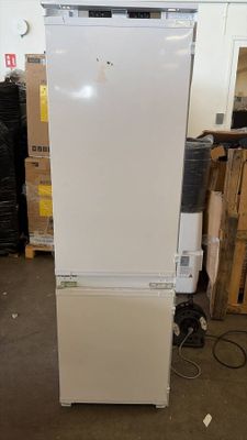 an image of a white refrigerator in a warehouse