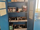 a blue cabinet with many items on it in a room