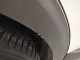 a close up of a tire on a white car