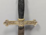 a sword with a gold and black handle