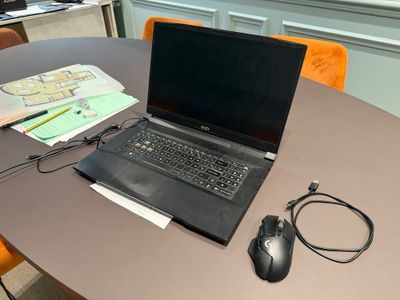 a laptop computer sitting on a table with a mouse