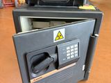 a black safe box with a key lock on top of it