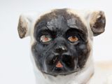 a figurine of a pug with a black face