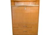an image of a tall wooden cabinet with drawers and shelves
