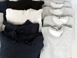 a lot of t - shirts laid out on a table