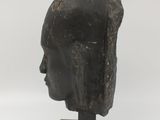 sculpture of a woman ' s head on a wooden base
