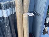 many rolls of fabric on the shelf in the store