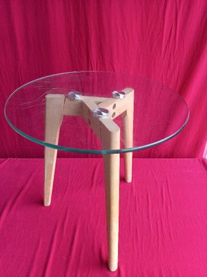 a glass table with wooden legs and a glass table top