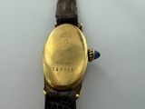 a close up of a wrist watch with a gold plated case