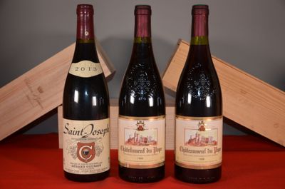 three bottles of wine sit on a table next to a wooden box
