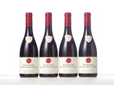 three bottles of red wine sitting on top of a white table
