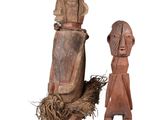 pair of wooden figurines of a man and a woman on a white background