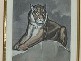 painting of a tiger resting on a rock in a gold frame