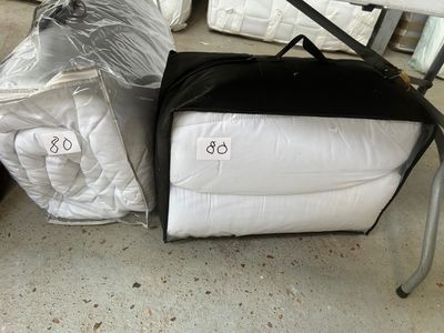 two bags of bedding on the ground next to each other