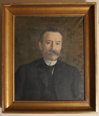 portrait of a man in a black coat and a white collared shirt