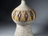 a vase that has a light on top of it