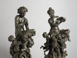 pair of bronze figurines of a boy and a girl with a dog