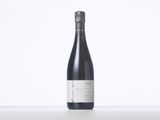 a bottle of wine sitting on top of a white table