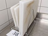 a stack of cutting boards sitting on a metal counter