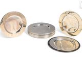 three plates and a silver plate on a white background