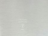 an image of a close up of a silver plate on a table