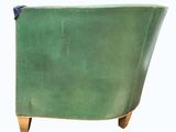 an image of a green leather chair with wooden legs