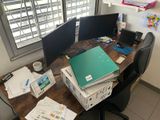 a desk with two computer monitors and a laptop on it