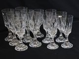 six crystal wine glasses are lined up on a black surface