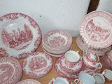 many different types of red and white plates on the table