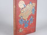 un vieux livre rouge orné de lettres dorées, posé sur une surface blanche