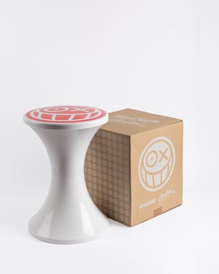 a white stool with a red and white design on it