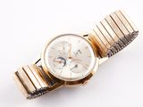 an image of a close up of a wrist watch on a white surface