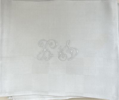 a close up of a napkin with a monogram on it