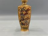 an image of a gold vase with a dragon design on it