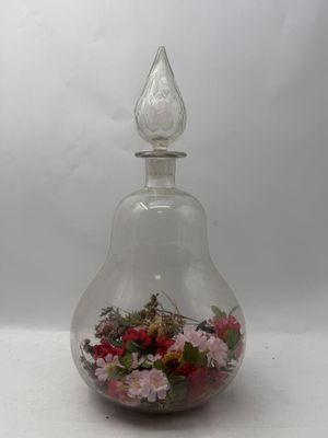 a glass vase with flowers inside of it on a table