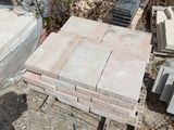 a pile of bricks sitting on the ground next to a fence