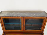 a wooden cabinet with a marble top and glass doors