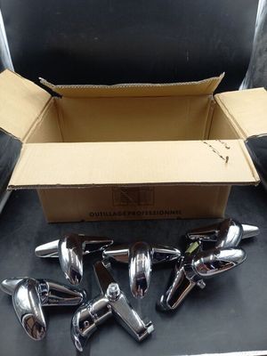 a box with a bunch of chrome handles on a table