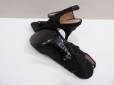 pair of black high heeled shoes on a white surface
